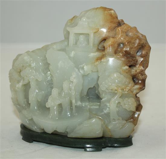 A Chinese pale celadon and russet jade boulder carving, height 10cm